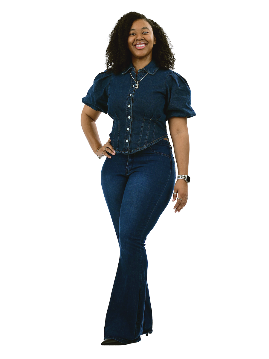 A female student in a denim outfit stands with her hand on her hip.