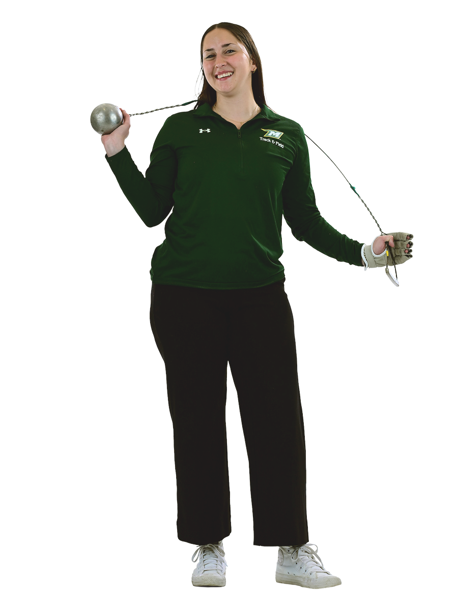A female student in McDaniel athletic gear poses with a throwing weight.