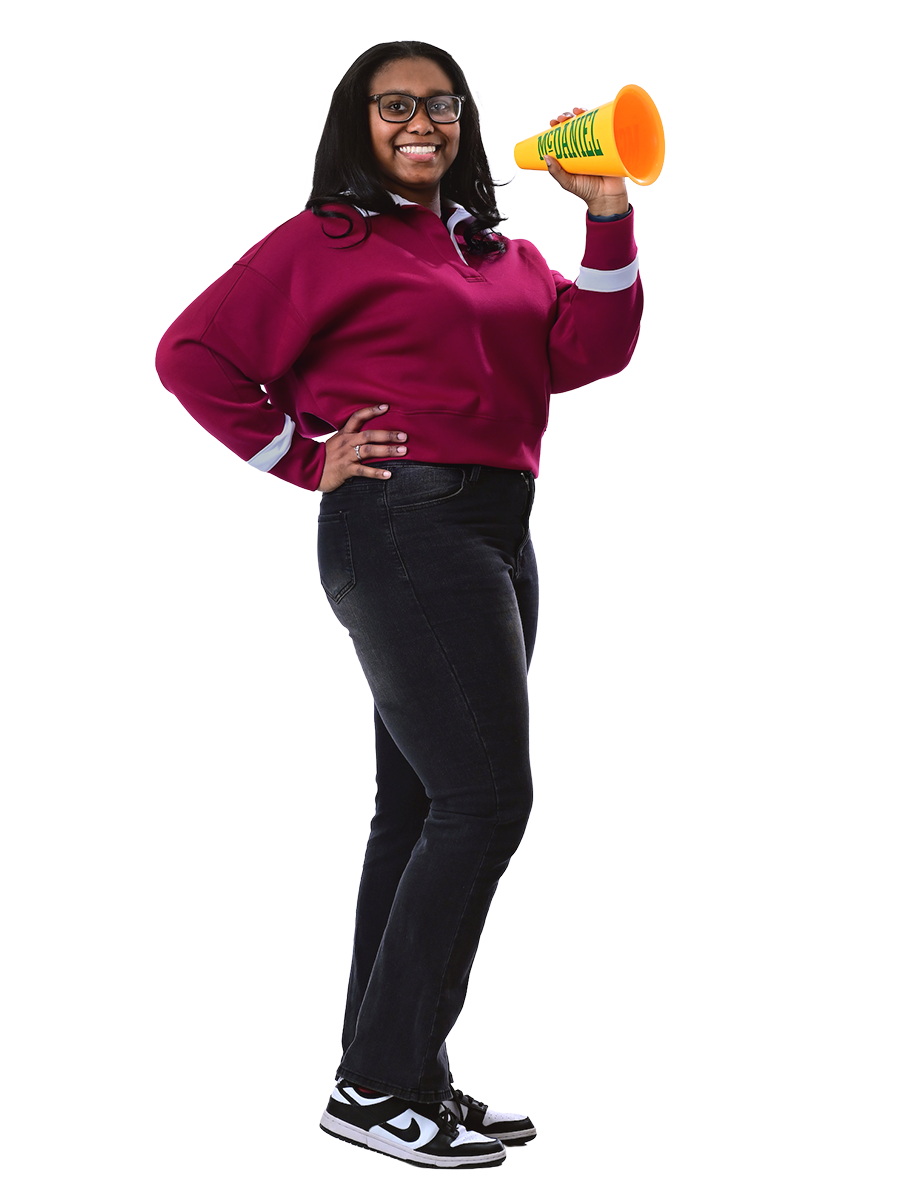 A female student smiles and holds a McDaniel megaphone.