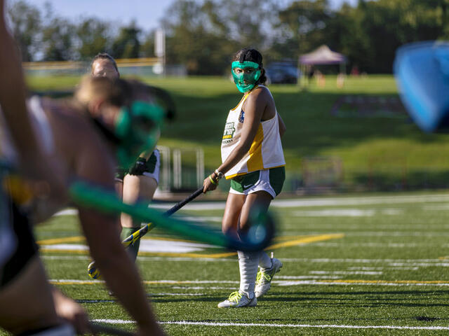Field Hockey players in action on the field.