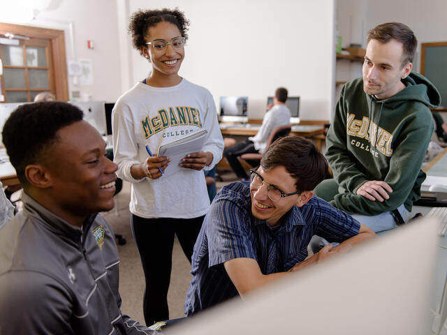 Professor interacting with students.