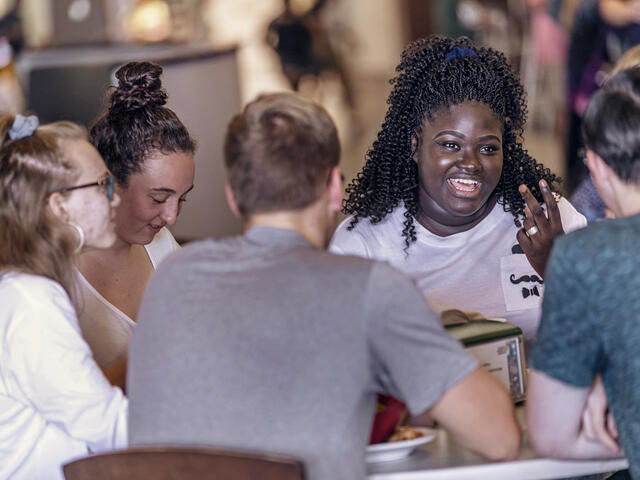 Students in conversation at table in Englar Dining Hall.