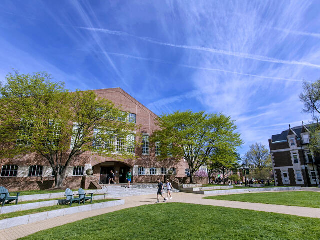 Student walking in front of Hoover Library.