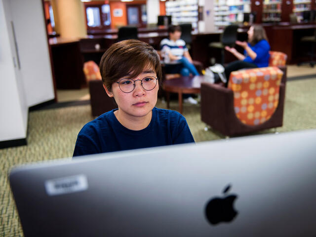 Grad student on computer.