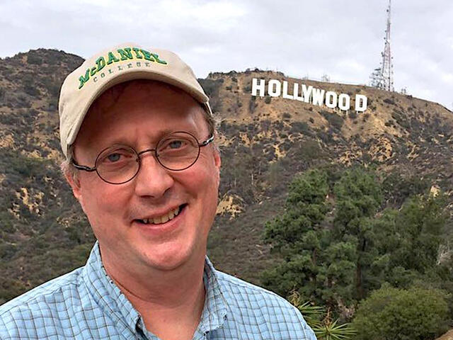  Hollywood Insider Jonathan Slade, Cinema Prof in front of Hollywood sign.