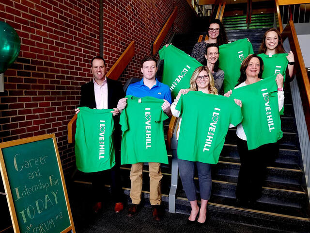 Alumni stand in Decker before a job and internship fair. 