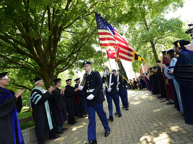 Walking the flags across campus at Commencement.