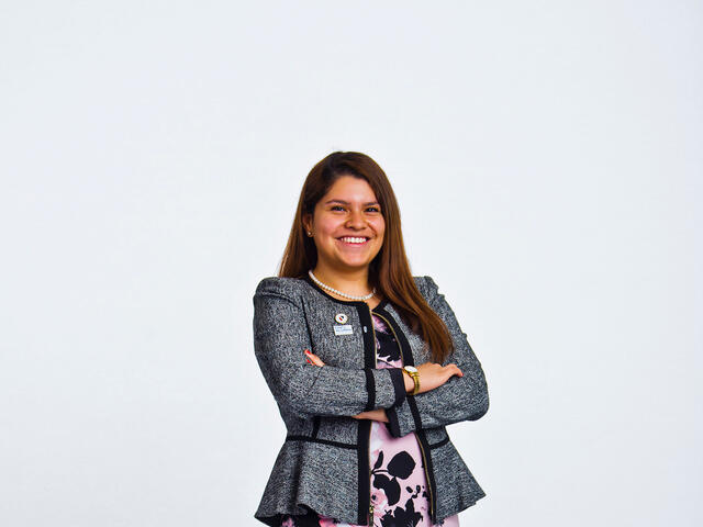 Jasmin Chavez standing in front of a white background.