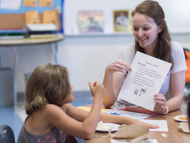 Student teaching one-on-one in elementary school setting.