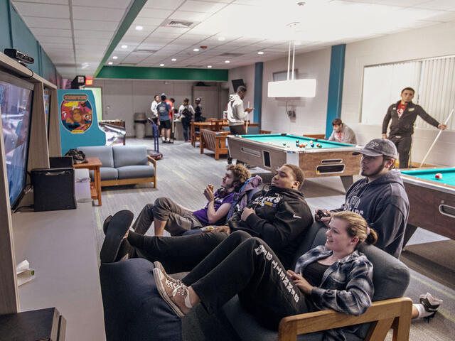 Students playing video games in Rec Room on campus.