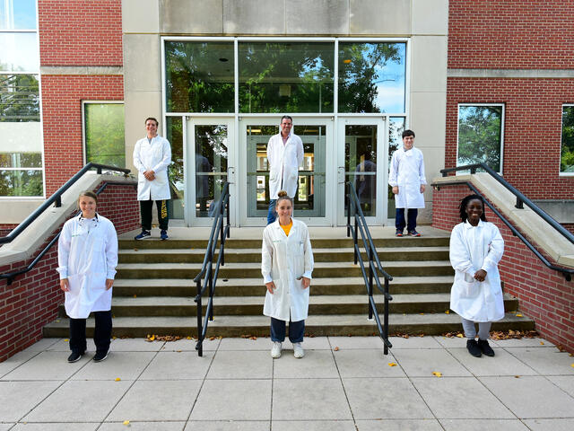 2020 summer research students and professor Dana Ferraris on Eaton Hall steps