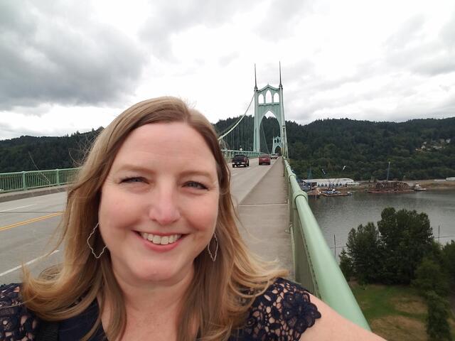 Ginger Bandeen posing in front of a bridge.