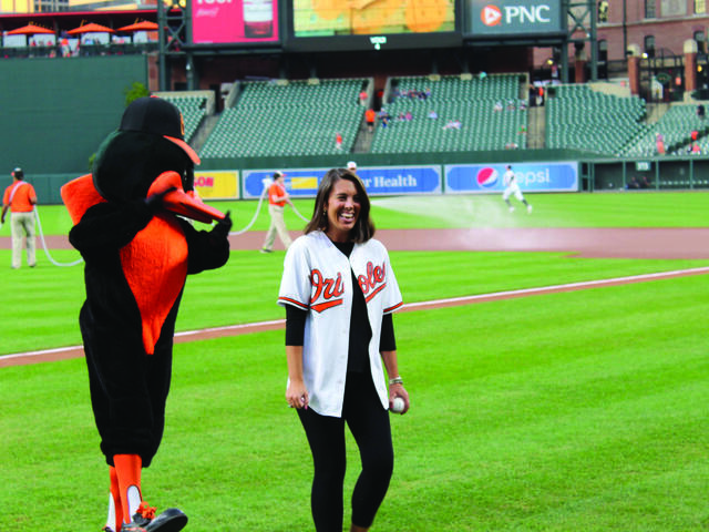 Alumna Lauren Avery '14 throwing the first pitch at an Orioles game.