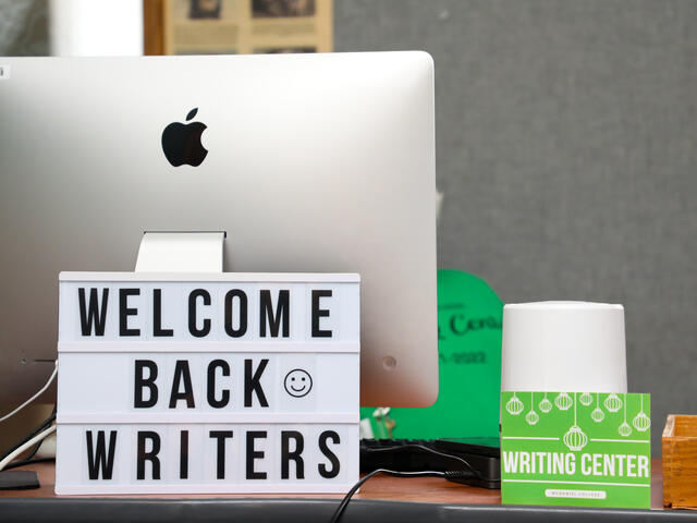 Sign saying "Welcome Back Writers" on the Writing Center front desk.