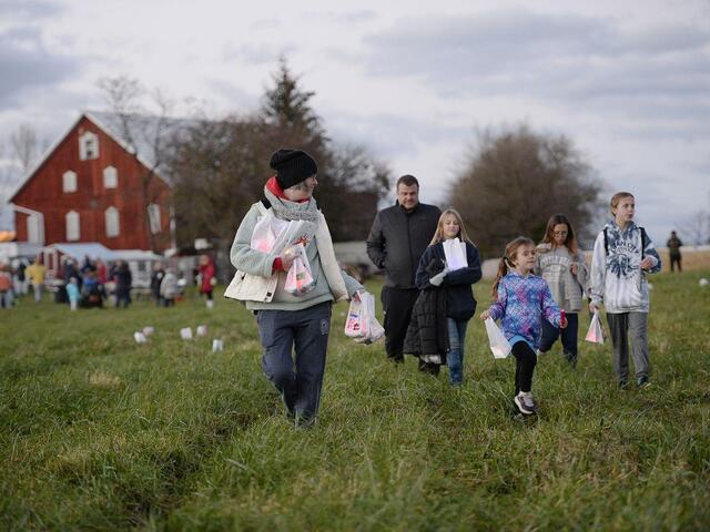 Clare Hoerl walking in a field with children.