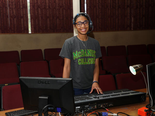 Student Kim Parson at the lightboard in the theatre.