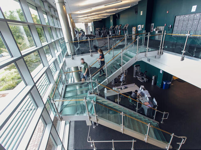 Photo from above of the staircase and equipment in Merritt Fitness Center.