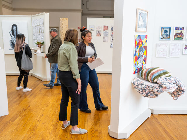 Students look at art exhibits