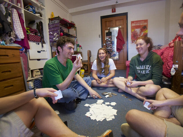 students in a circle playing cards