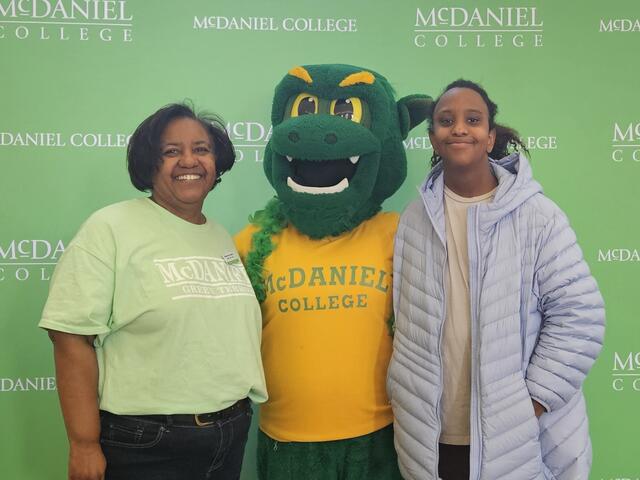 Michele Curry-Creighton poses with her daughter Jordan with the Green Terror mascot.