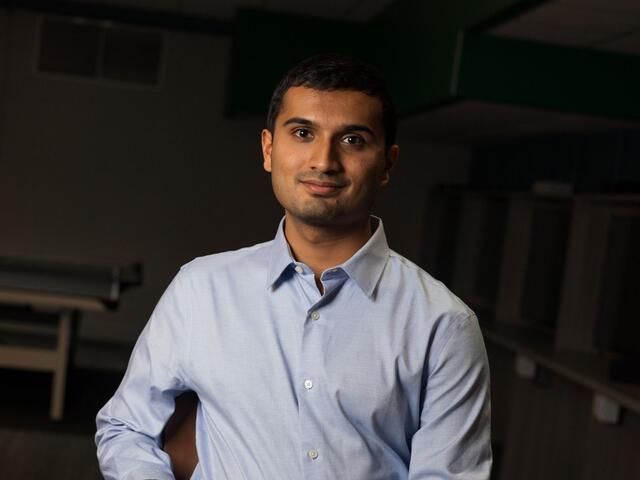 Portrait of Nikhil Niyogi. He is wearing a blue button-down shirt.