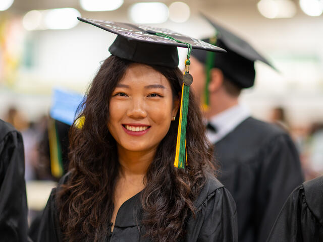 Photos of an Asian woman smiling while wearing graduation regalia.