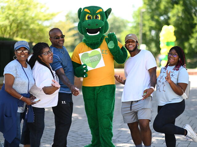 Family smiling and posing with the Green Terror