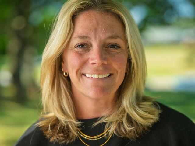 Rachel Guilfoyle smiles outside while wearing a black blouse.