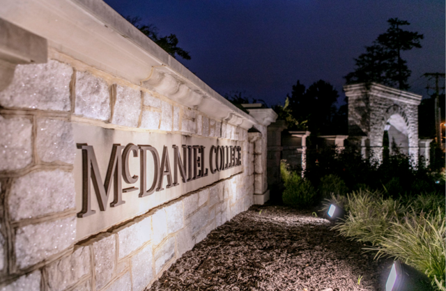 McDaniel campus sign in front of arch