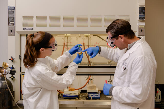 Professor with student in research lab.