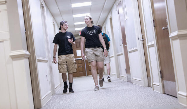Students walking in residence hallway.