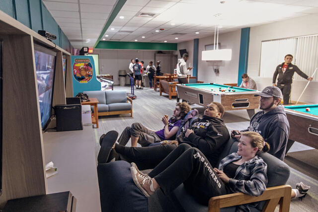 Students playing video games in Rec Room on campus.