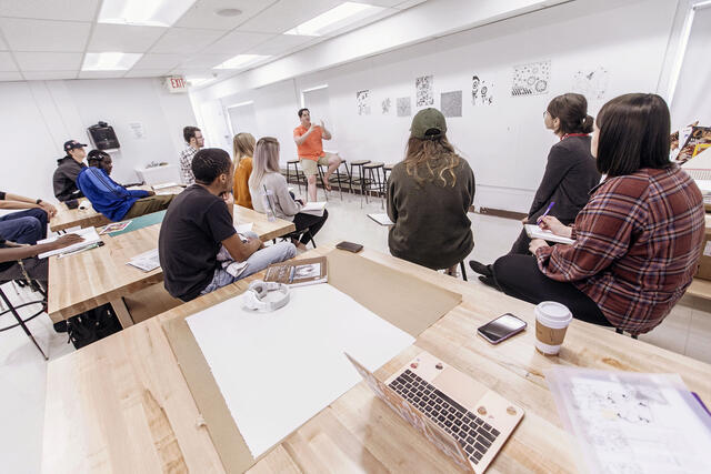 Art professor and students in art studio.