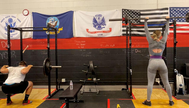 Valens Strength & Conditioning co-owners Jason Varnum and Nicole Rutherford ’16 lift at their Mission Valley, San Diego location.