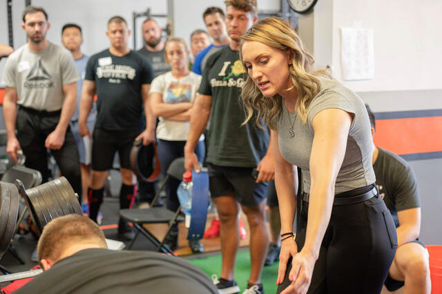 Nicole Rutherford ’16 teaches the deadlift as a platform coach at the L.A. Starting Strength seminar.