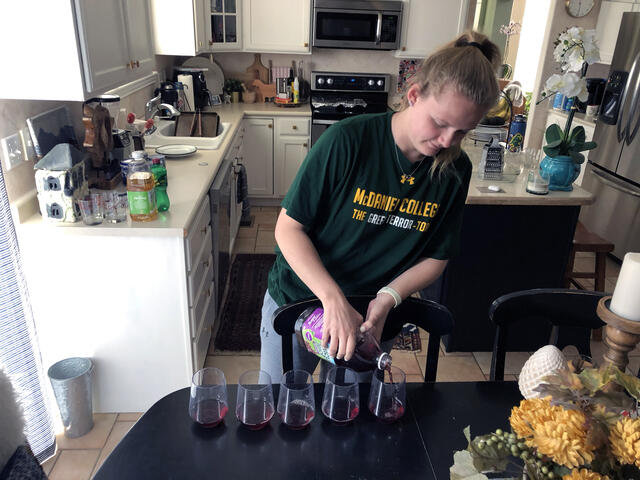 Annalise Bell, a junior Kinesiology major from Highlands Ranch, Colo., uses grape juice to test acids and bases at home.  
