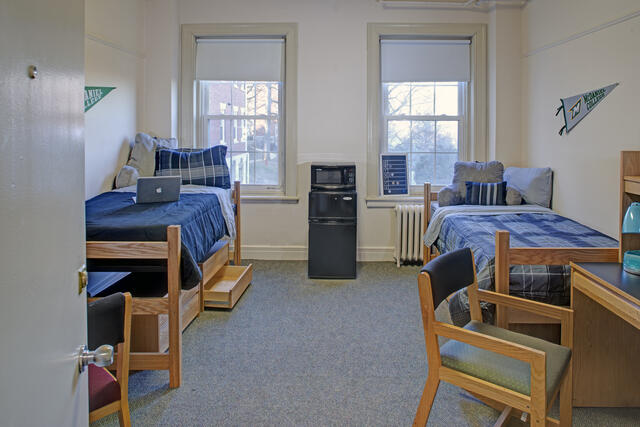 Student Dorm room with 2 beds desks and decorations
