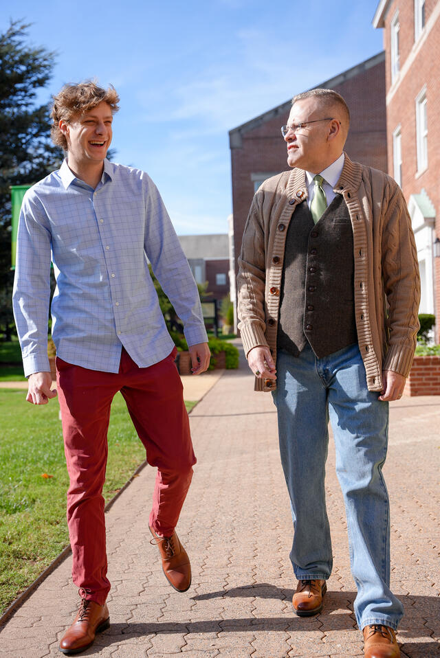 Alum Dominic Byerly walking with professor Kevin McIntyre.