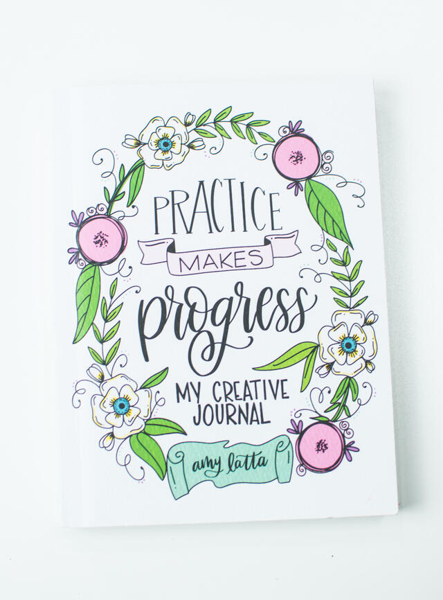 The cover of the hand lettering book "Practice Makes Progress" by Amy Latta.