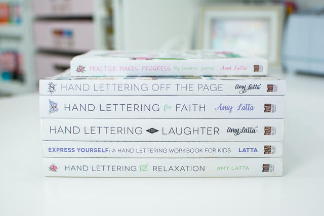 Book spines of Amy Latta's hand lettering books.