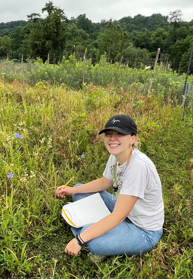 Student Hailey Grzemkowski observing flowers at MEC