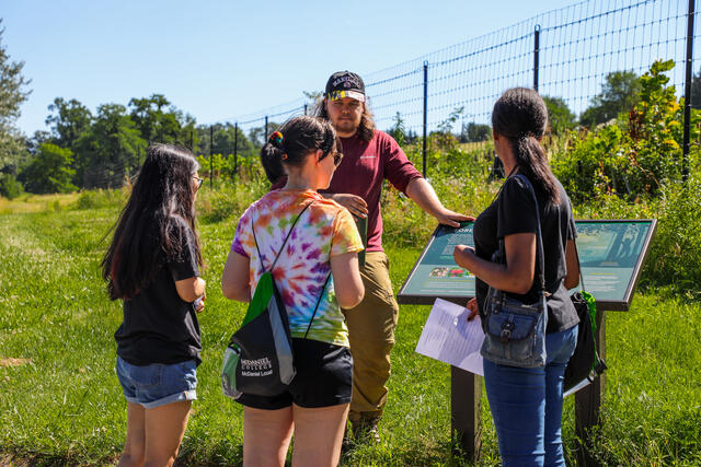 Students look at a nature sign at the Environmental Center.