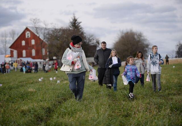 Clare Hoerl walking in a field with children.