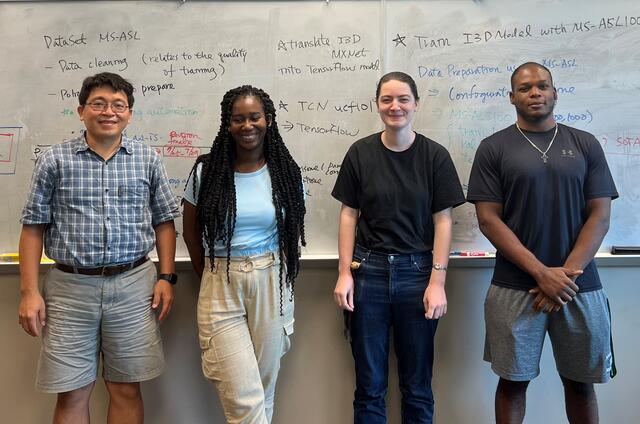 Professor Lin stands with his three summer 2022 research students.