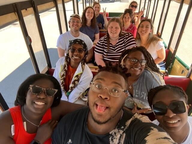 Group of students sitting in a train car.