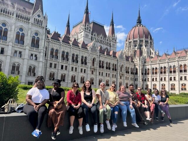 Group photo of students outside the Hungarian Parliament building in Budapest.