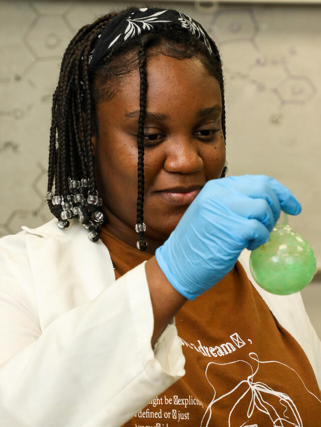 A student examines a compound in the lab.