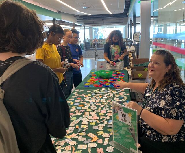 Christine Moran supports students at a table for National Suicide Prevention Awareness Month.