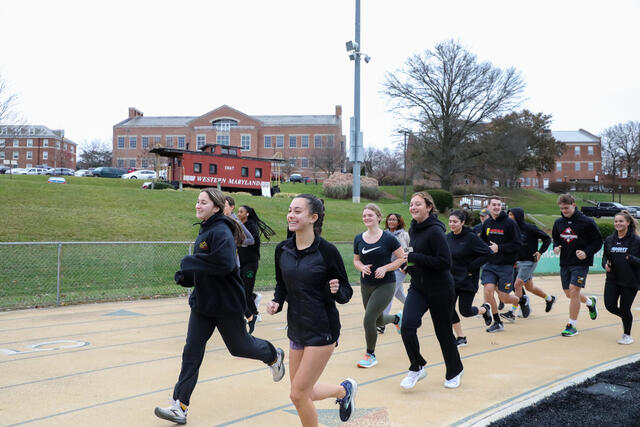 Students in Find Your Strong: Running for Your Life jog on a track.