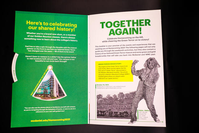 A photo of a booklet open to a page reading "Together Again" and showing an image of a historic Green Terror mascot.